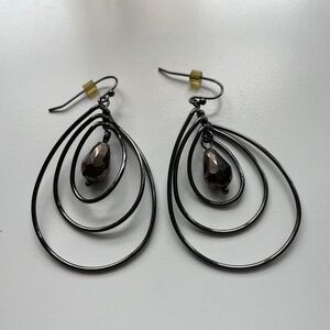 Black wire tri-hoop earring with swinging chocolate brown crystal drop. 2-1/2"